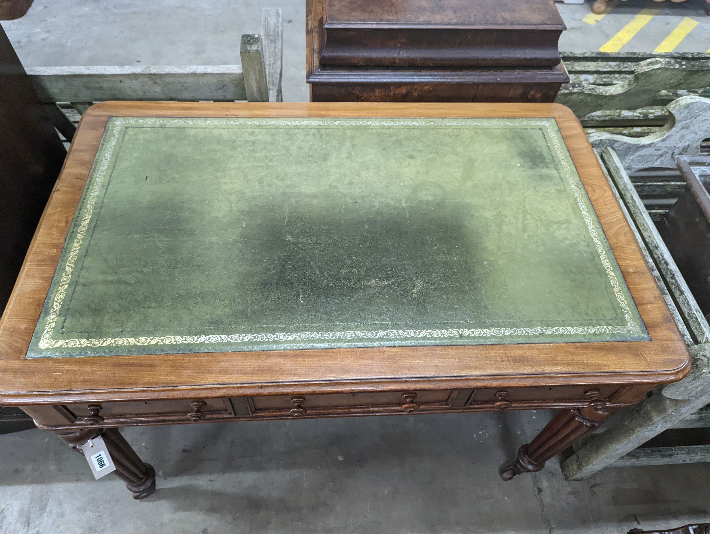 A Victorian mahogany three drawer writing table on fluted legs, width 106cm, depth 66cm, height 75cm